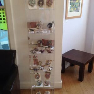 Craft Cabinet artwork displayed in glass cabinet on different shelves