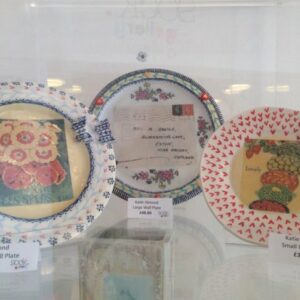 Artwork from the Craft Cabinet displayed in a glass container on a shelf