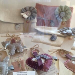 Artwork from the Craft Cabinet displayed in a glass container on a shelf